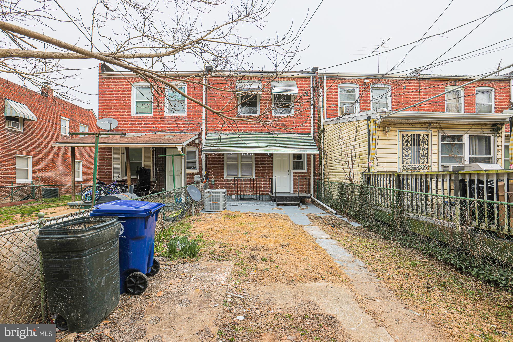2454 Terra Firma Road Baltimore, MD 21225 - Photo 42 of 44 a view of a brick house with large windows and a small yard