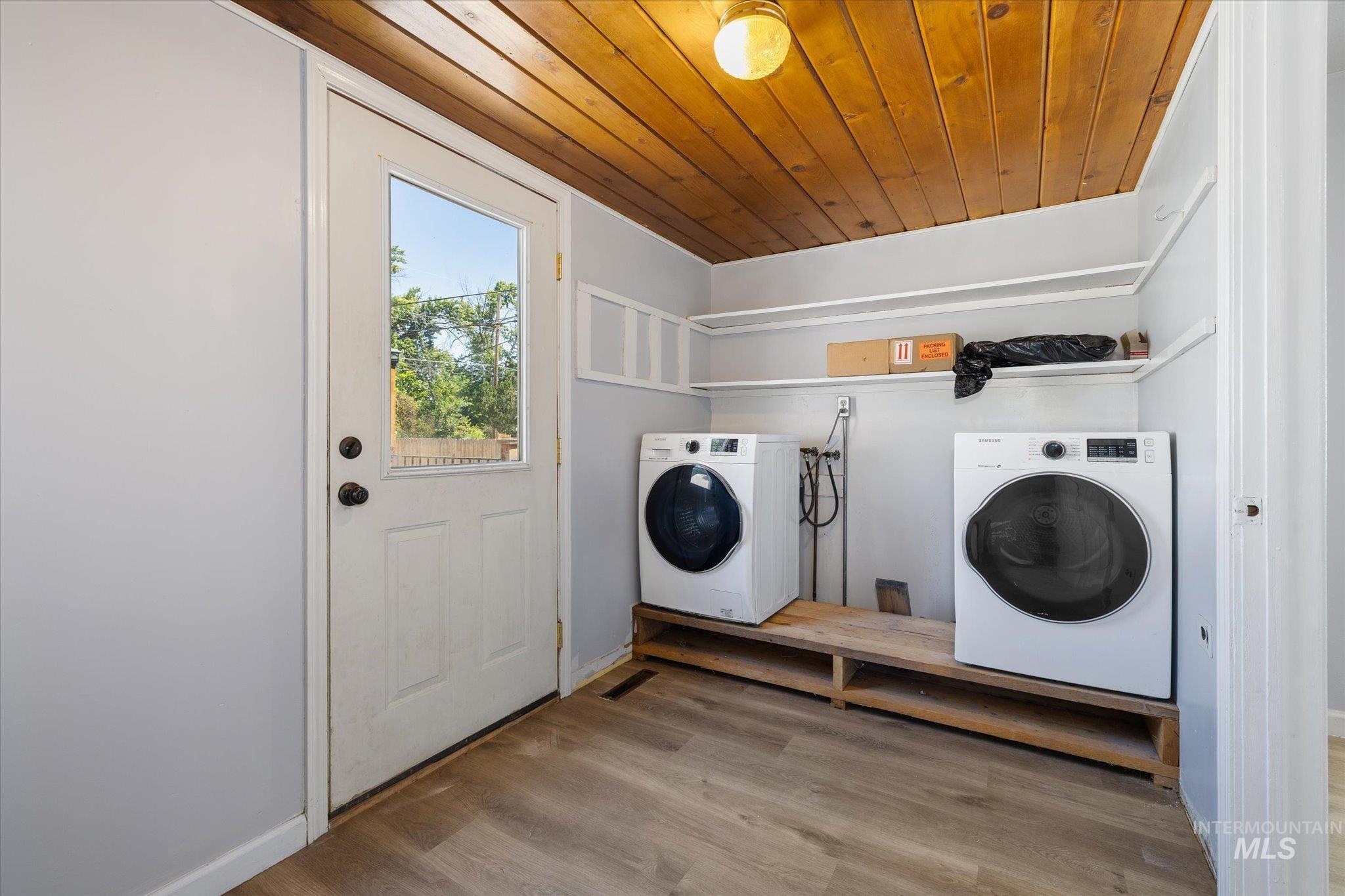 918 West 3rd Street Weiser, ID 83672 - Photo 22 of 36 Laundry area featuring wood-finish flooring, a paneled wood ceiling, and built-in shelving