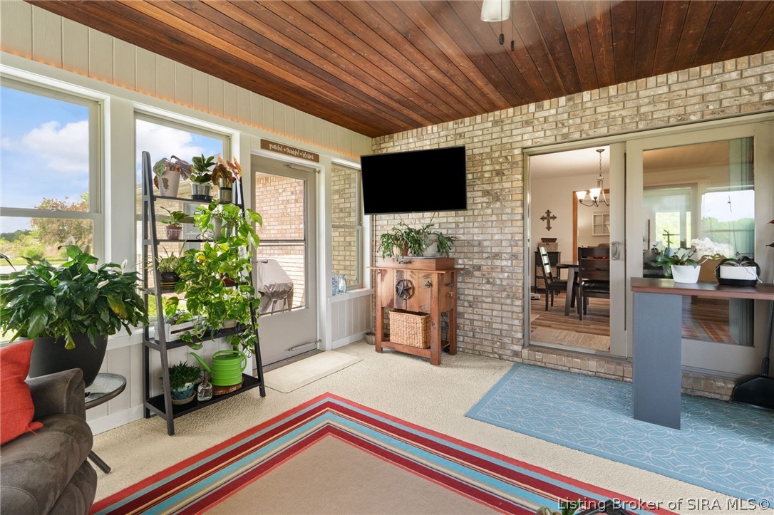 700 South 1233rd West Lexington, IN 47138 - Photo 11 of 65 All season room with brick accent wall, wood ceiling and exposed aggregate flooring!