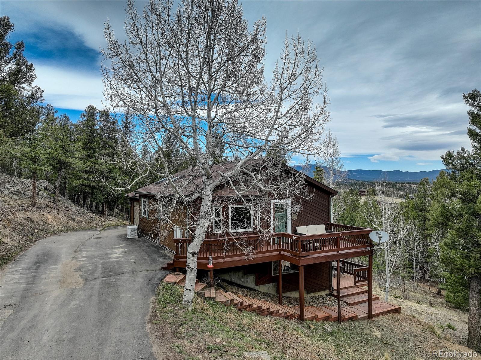 261 Mt Bailey Drive Bailey, CO 80421 - Photo 1 of 28 a view of a wooden deck with a yard