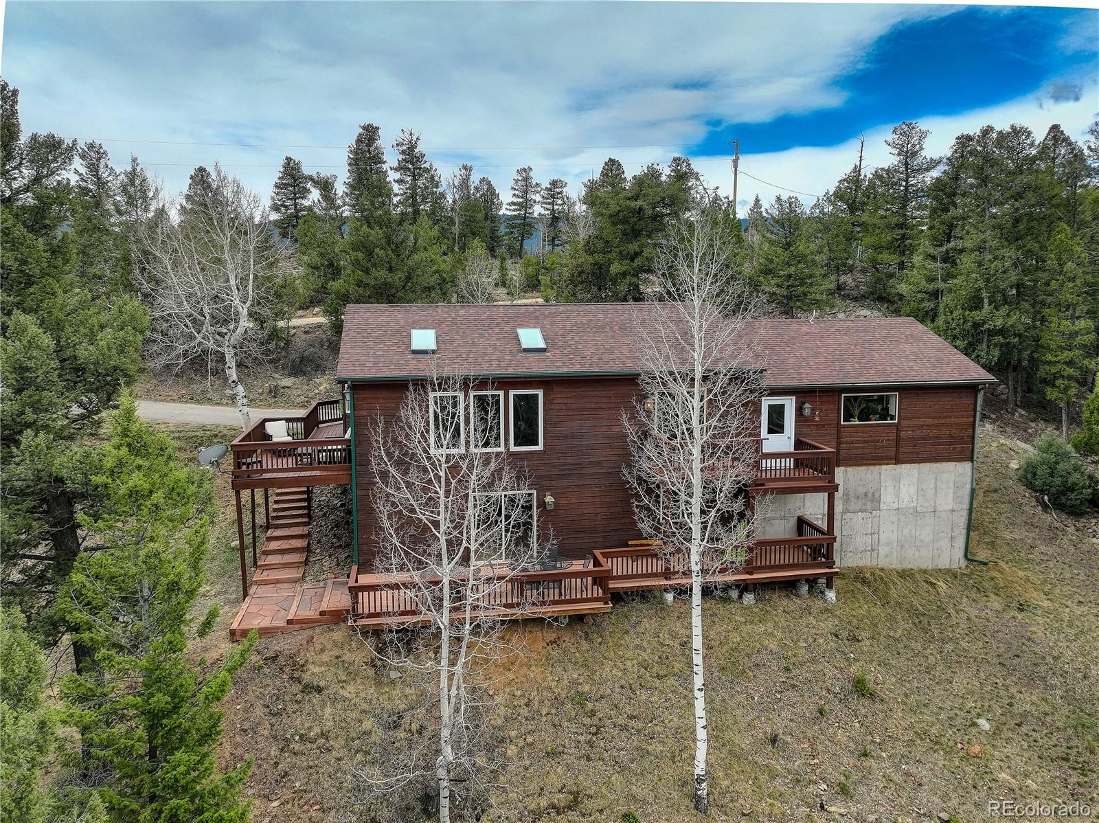 261 Mt Bailey Drive Bailey, CO 80421 - Photo 13 of 28 aerial view of a house with a yard balcony and trees in the background