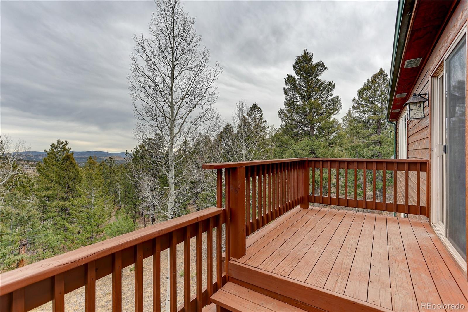 261 Mt Bailey Drive Bailey, CO 80421 - Photo 21 of 28 a balcony with wooden floor and fence