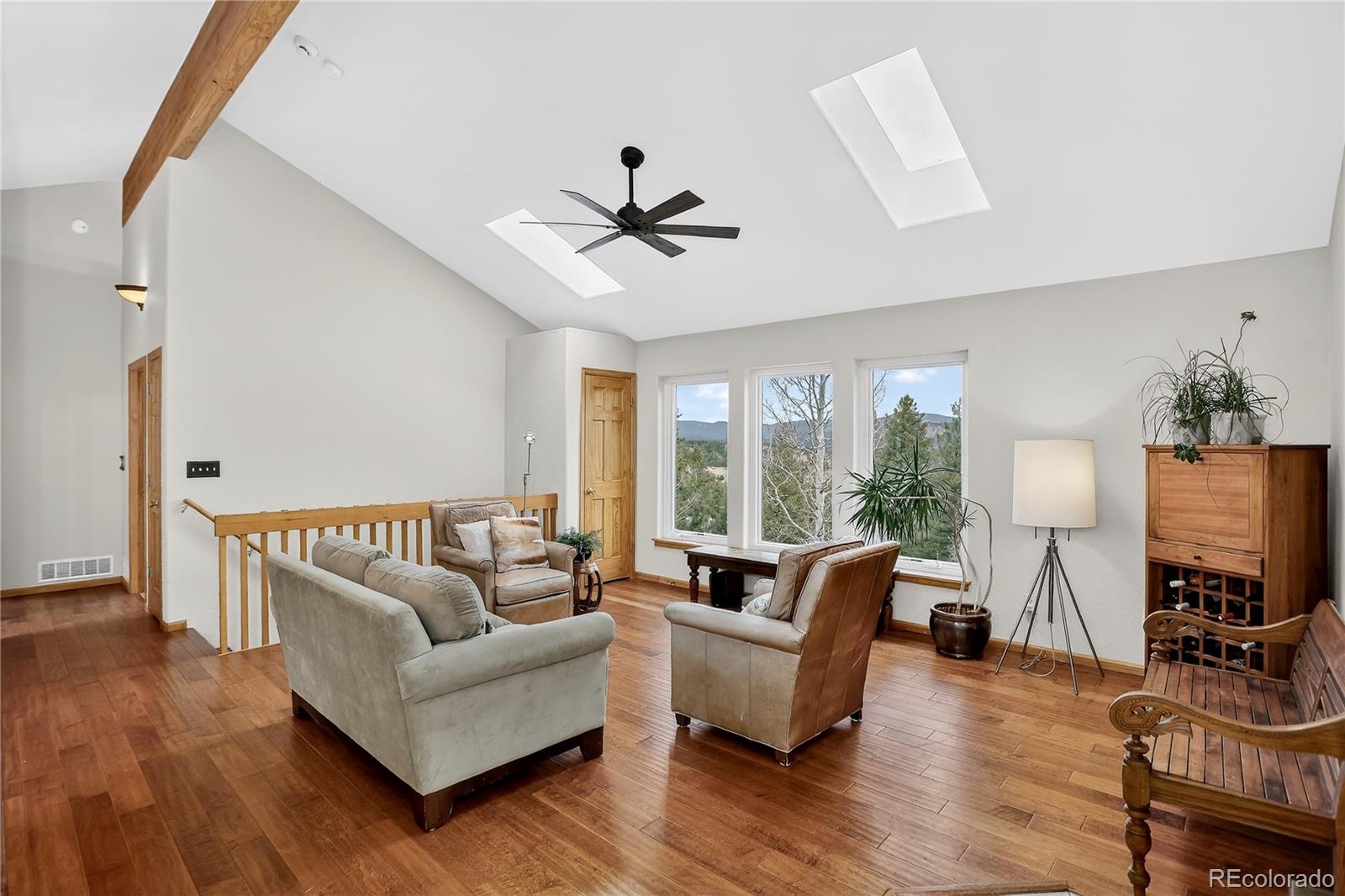 261 Mt Bailey Drive Bailey, CO 80421 - Photo 5 of 28 a living room with furniture flat screen tv and a large window