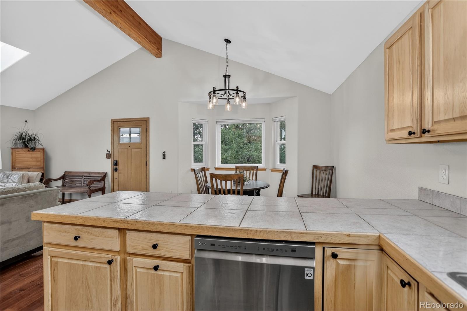 261 Mt Bailey Drive Bailey, CO 80421 - Photo 9 of 28 a kitchen with a stove and chandelier