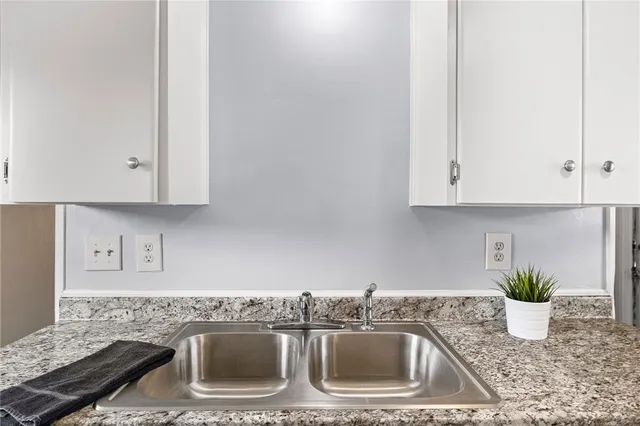 a kitchen with a sink and cabinets