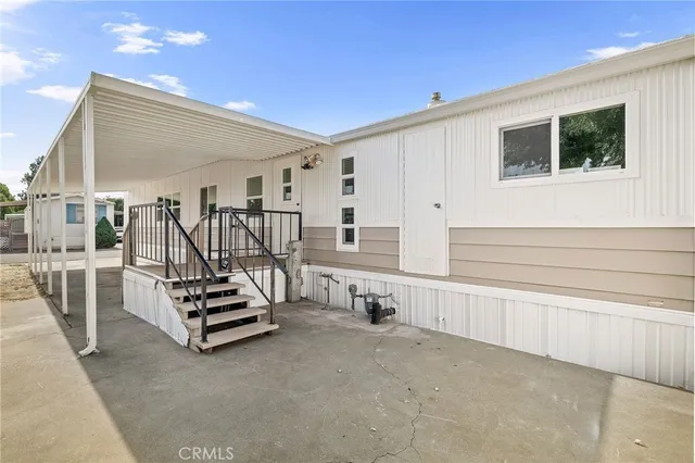 a view of kitchen with stainless steel appliances cabinets and outdoor space