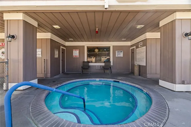 a view of a swimming pool with an outdoor seating