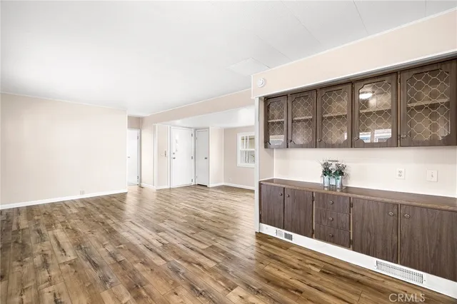 a view of a kitchen with wooden floor and a sink