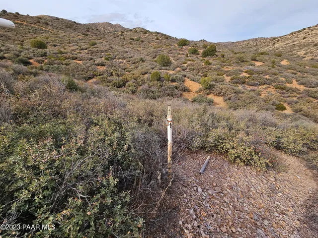 a view of a large mountain with mountains in the background