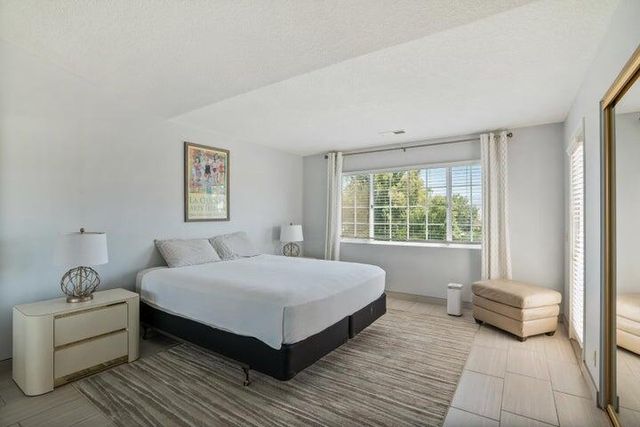 a bedroom with a bed and a couch