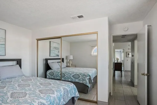 a bedroom with a bed and mirror