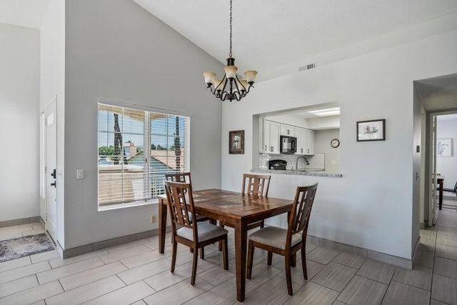 a view of a dining room with furniture and a chandelier