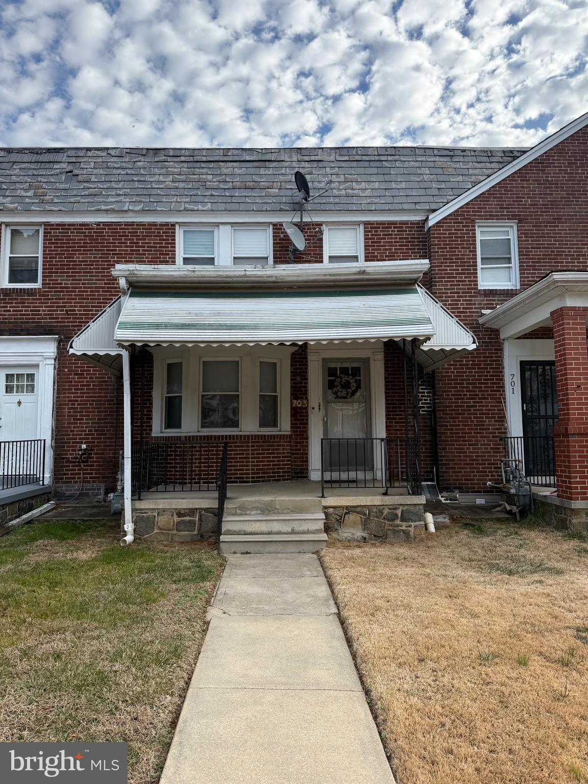 703 North Augusta Avenue Baltimore, MD 21229 - Photo 1 of 7 front view of a house with a yard