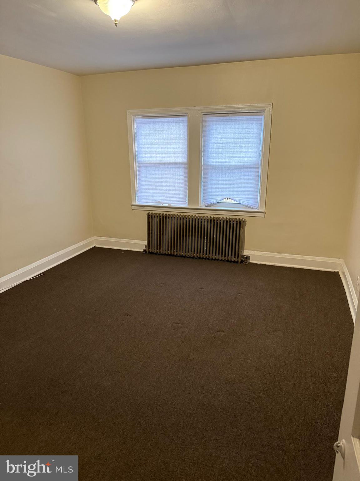 703 North Augusta Avenue Baltimore, MD 21229 - Photo 5 of 7 a view of an empty room with a window
