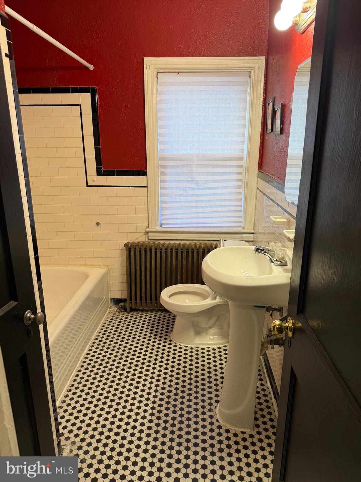703 North Augusta Avenue Baltimore, MD 21229 - Photo 6 of 7 a bathroom with a sink a toilet a mirror and shower