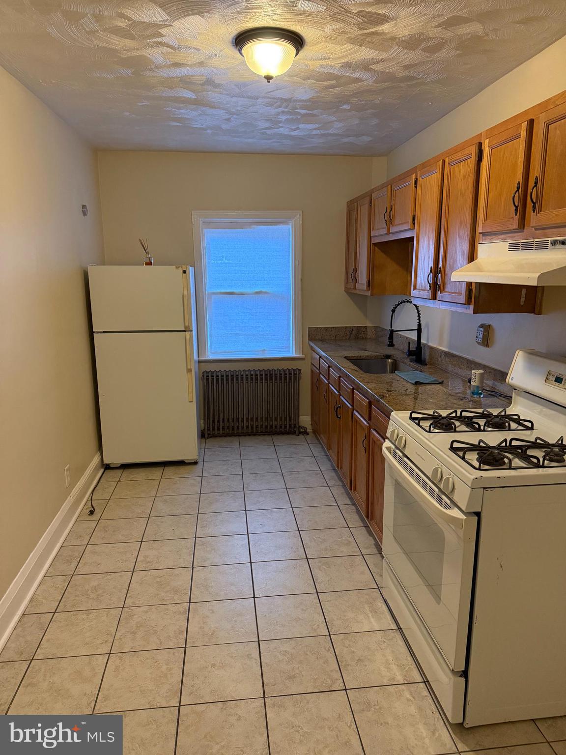 703 North Augusta Avenue Baltimore, MD 21229 - Photo 7 of 7 a kitchen with stainless steel appliances granite countertop a stove a sink and a refrigerator
