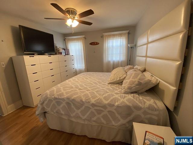 15 Hackensack Street East Rutherford, NJ 07073 - Photo 9 of 26 a bedroom with a bed and a flat screen tv