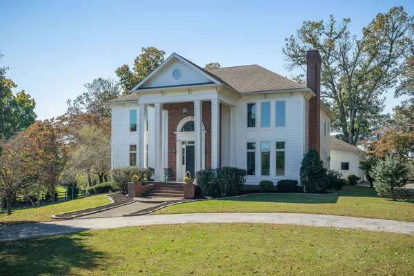 a front view of a house with outdoor seating and yard