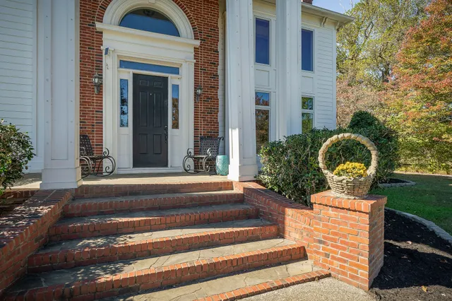 a front view of a house with outdoor seating and yard