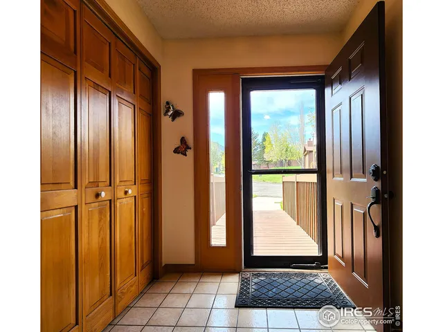 a view of a balcony with wooden floor and door