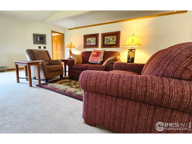 a living room with furniture and a lamp