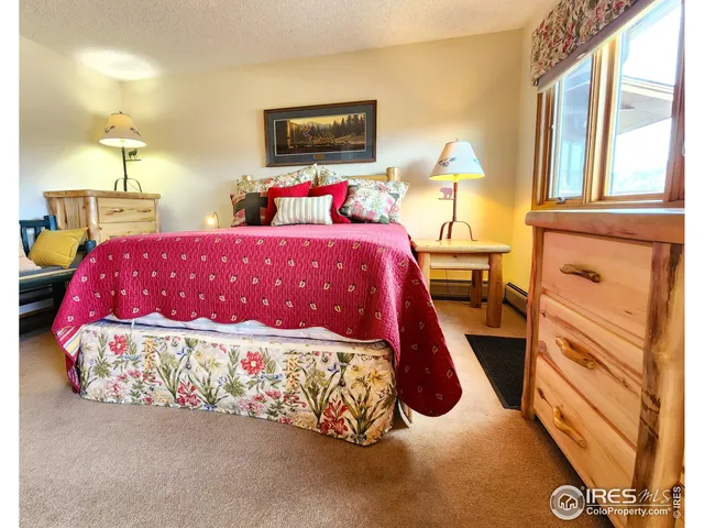 a bedroom with a bed and a night stand