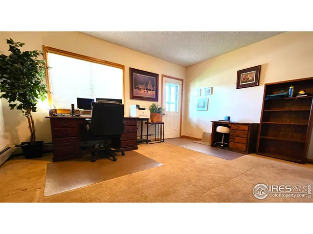 a bedroom with a bed and a wall painting