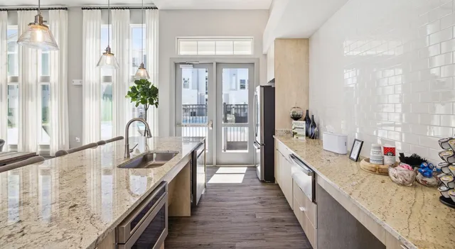 a kitchen with sink stove and refrigerator