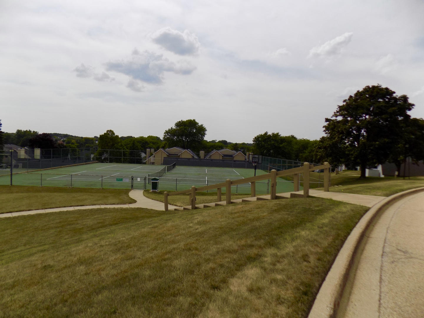 702 Chandler Road Gurnee, IL 60031 - Photo 18 of 26 a view of a swimming pool with a yard and large trees