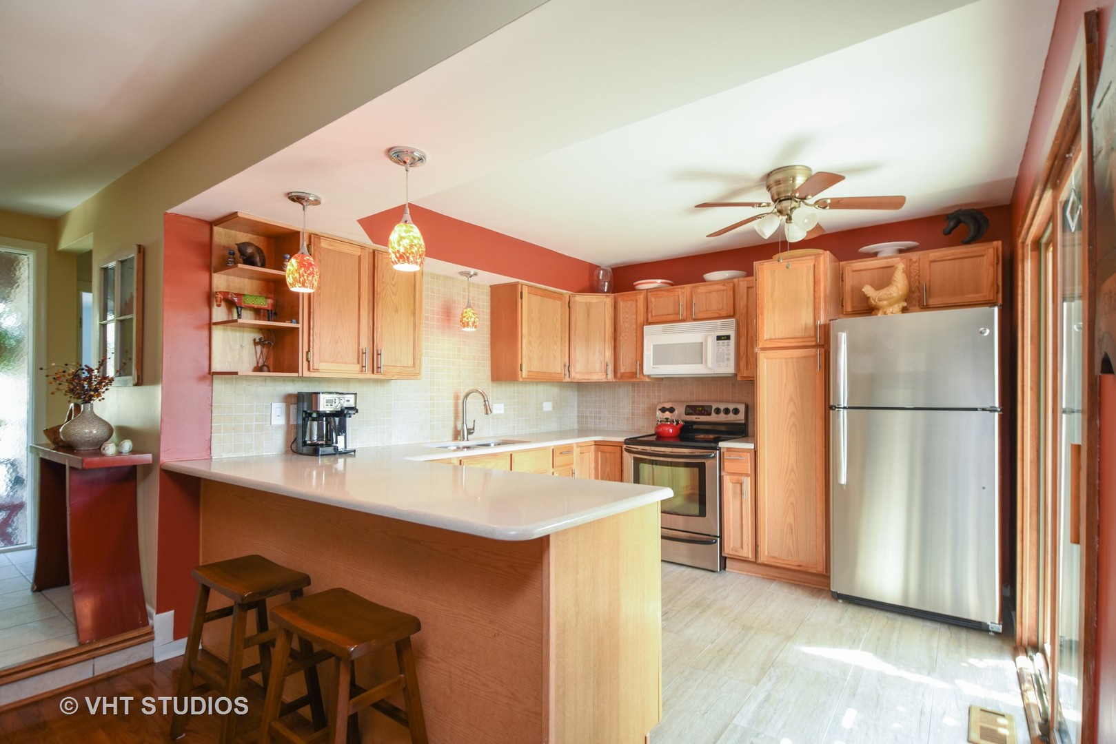 702 Chandler Road Gurnee, IL 60031 - Photo 2 of 26 a kitchen with a refrigerator a sink and a stove