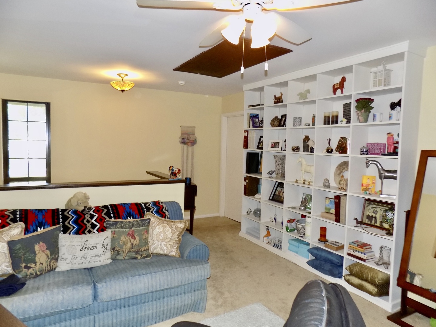 702 Chandler Road Gurnee, IL 60031 - Photo 25 of 26 a living room with lots of furniture and a book shelf