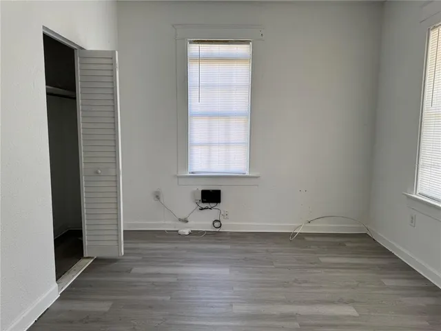 a view of a livingroom with wooden floor and a window