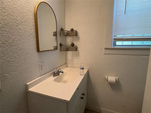 a bathroom with a sink and a mirror