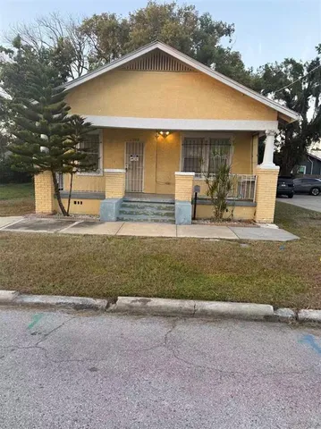 a view of two house with backyard and trees in the background