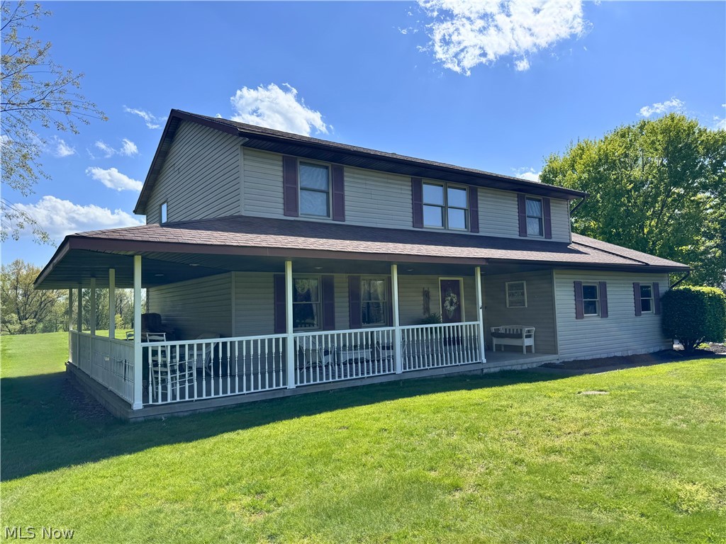 3906 Webb Road Ravenna, OH 44266 - Photo 1 of 33 Two-story residence featuring light-colored siding, a covered porch with white railing, and a shingled roof