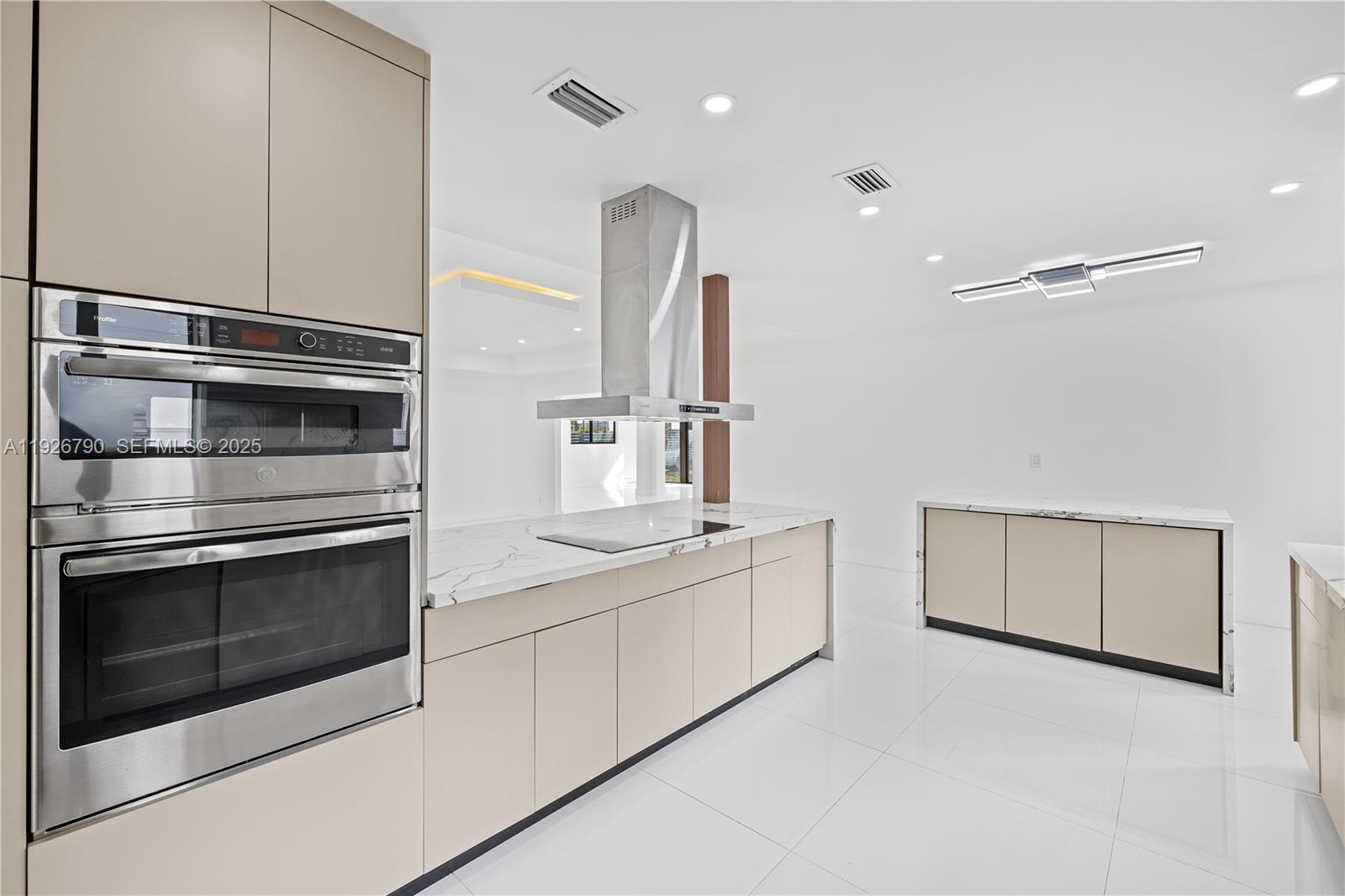 1200 Cleveland Road Miami Beach, FL 33141 - Photo 14 of 41 a kitchen with stainless steel appliances granite countertop a stove and a microwave