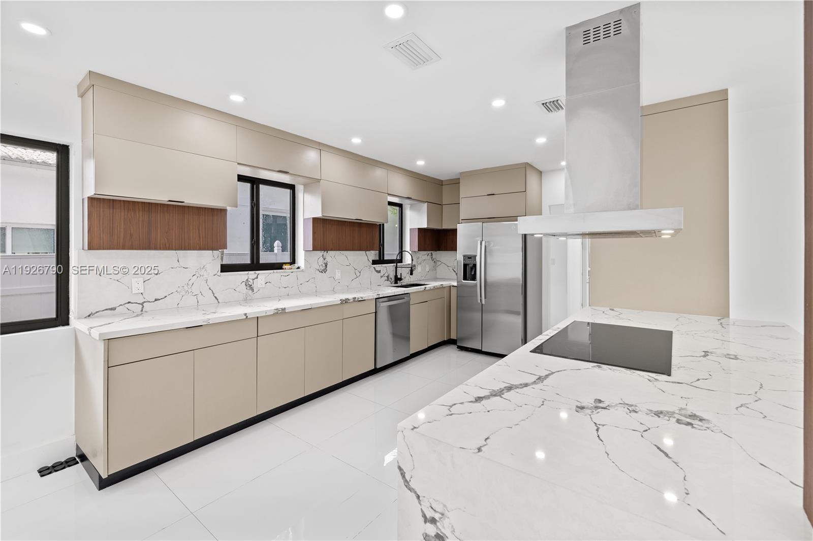1200 Cleveland Road Miami Beach, FL 33141 - Photo 15 of 41 a kitchen with granite countertop a sink stainless steel appliances and white cabinets