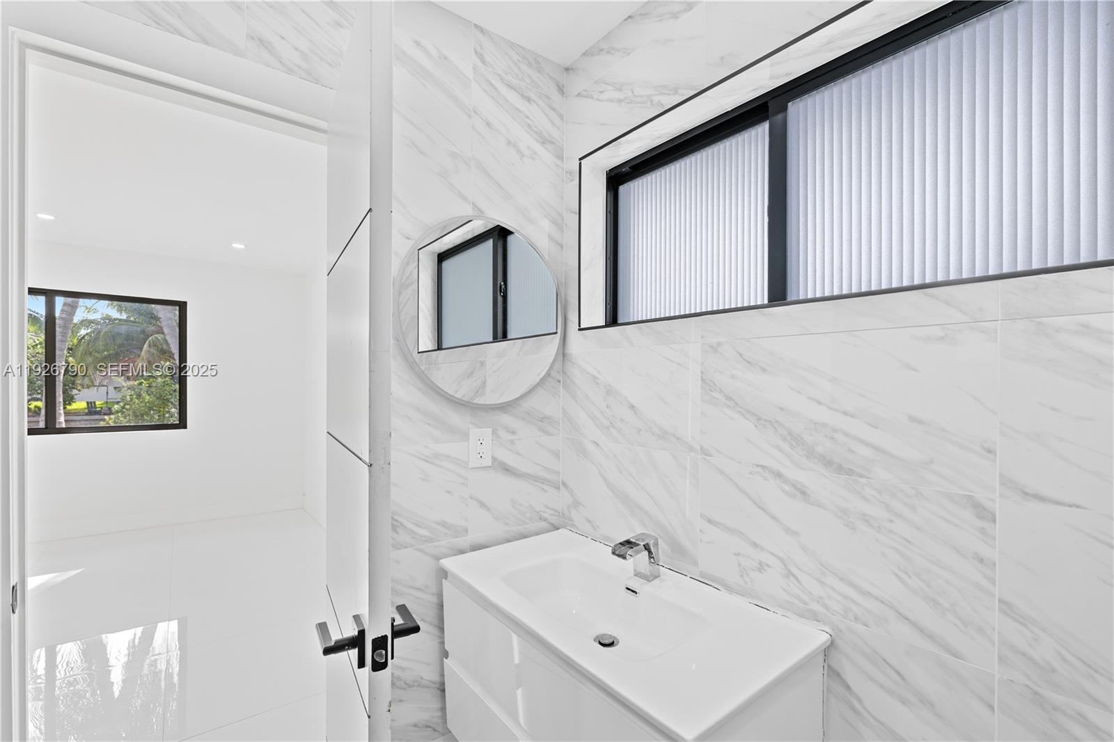 1200 Cleveland Road Miami Beach, FL 33141 - Photo 28 of 41 a bathroom with a sink and mirror