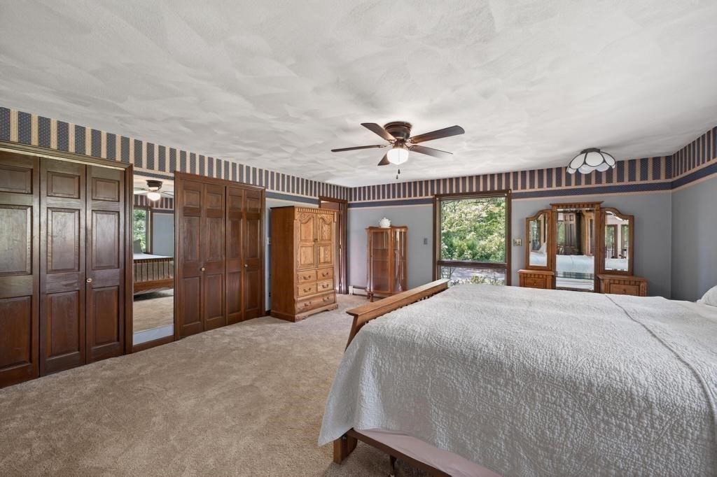 38 Gaudette Street Fall River, MA 02721 - Photo 33 of 41 a bedroom with a large bed and a chandelier