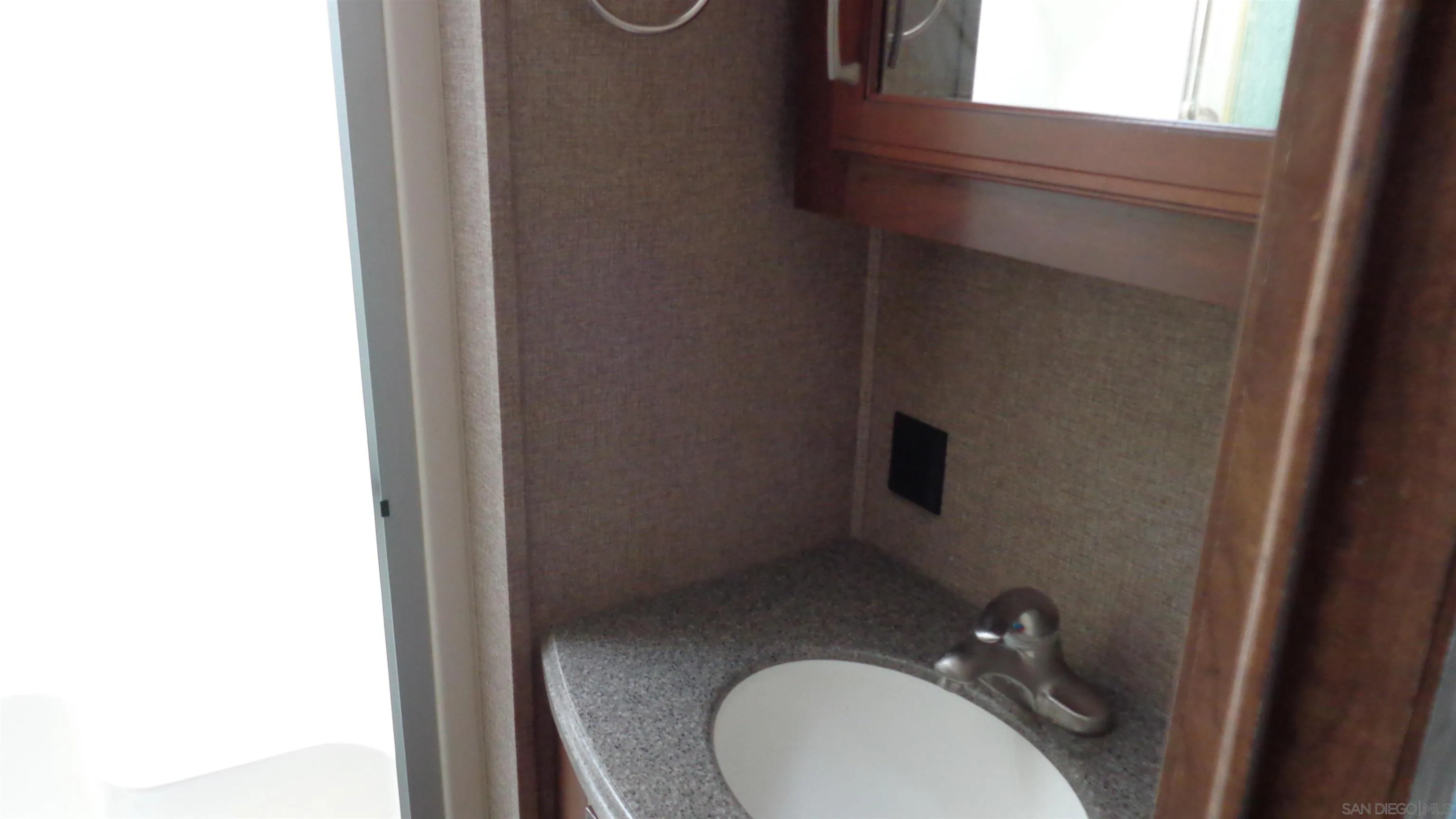 762 Taylor Street Vista, CA 92084 - Photo 9 of 13 a bathroom with a granite countertop toilet and a sink