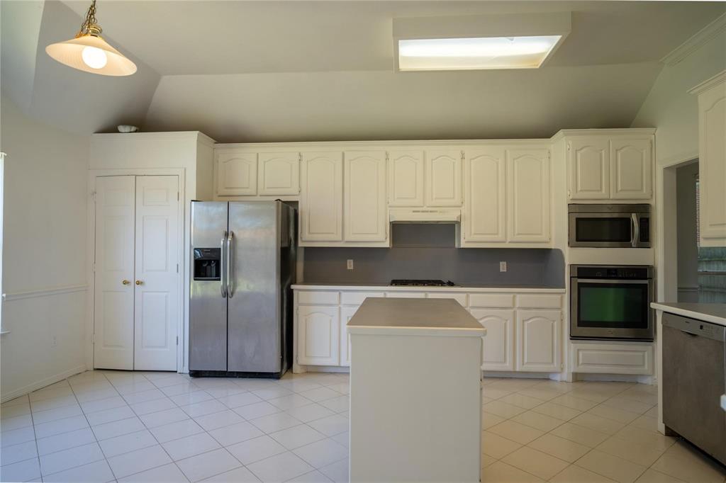 492 Shade Tree Circle Hurst, TX 76054 - Photo 11 of 20 a kitchen with a refrigerator sink and microwave