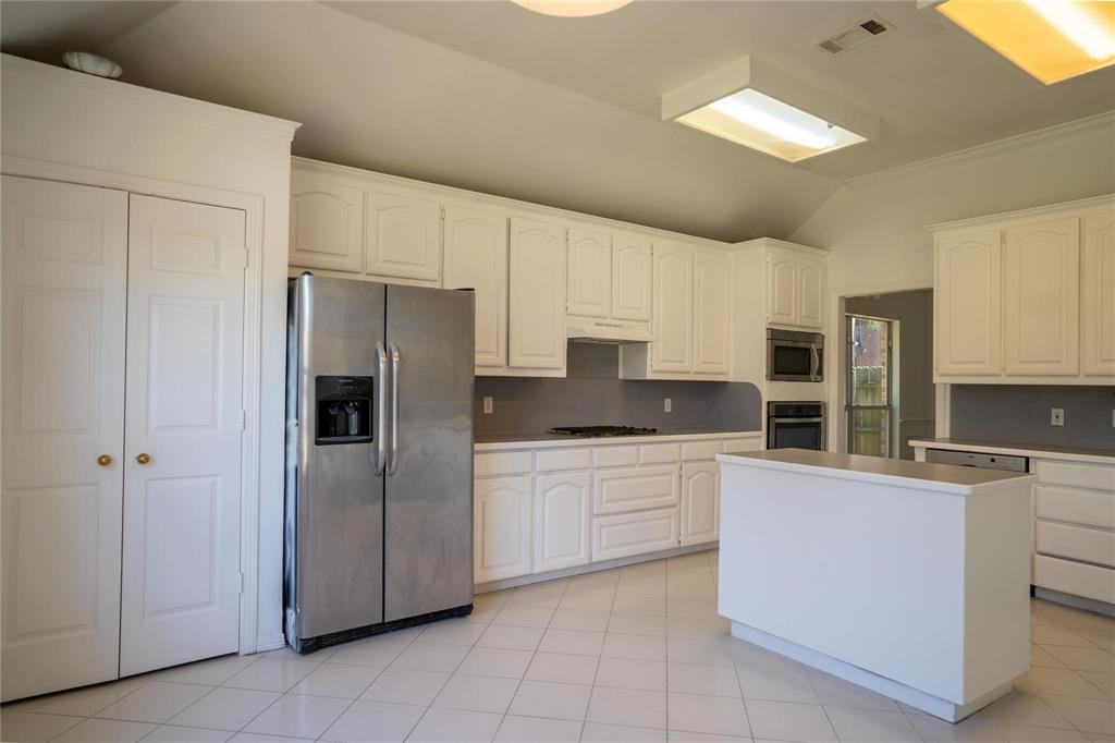 492 Shade Tree Circle Hurst, TX 76054 - Photo 12 of 20 a kitchen with stainless steel appliances a refrigerator sink and cabinets