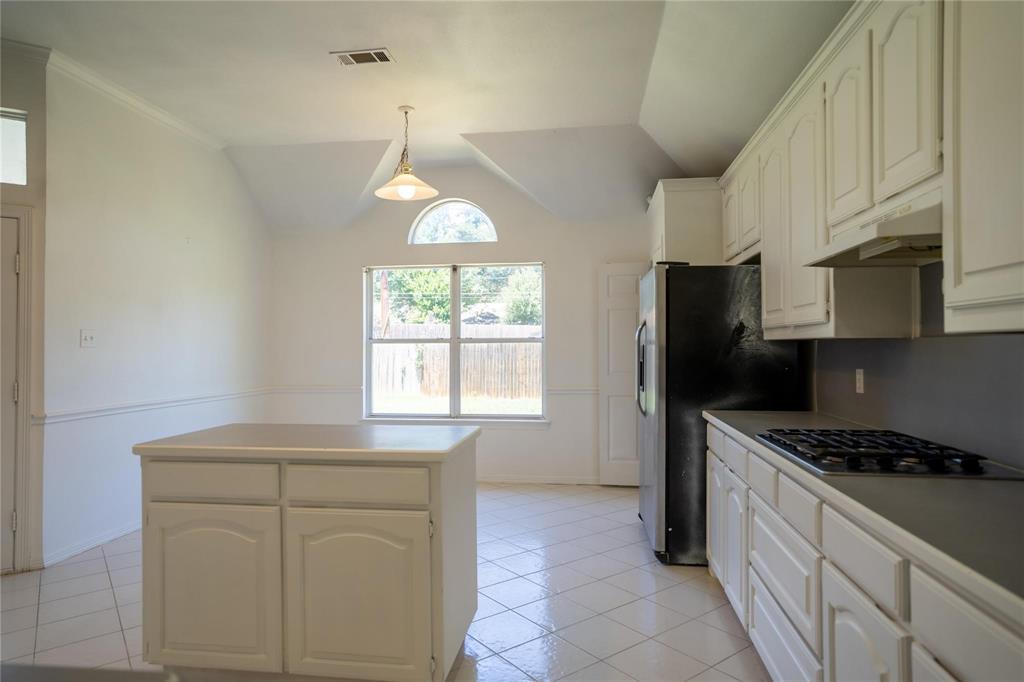 492 Shade Tree Circle Hurst, TX 76054 - Photo 14 of 20 a kitchen with stainless steel appliances a stove a sink cabinets and a window
