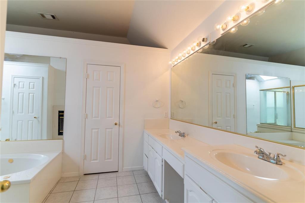 492 Shade Tree Circle Hurst, TX 76054 - Photo 18 of 20 a spacious bathroom with a tub sink shower and mirror