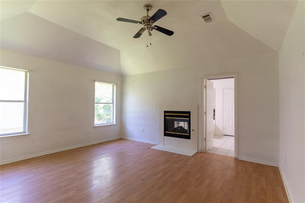 492 Shade Tree Circle Hurst, TX 76054 - Photo 20 of 20 a view of a livingroom with a fireplace a ceiling fan and wooden floor
