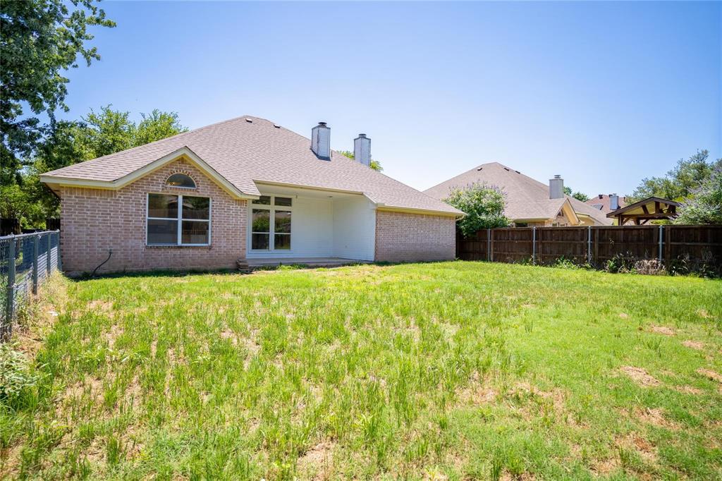 492 Shade Tree Circle Hurst, TX 76054 - Photo 4 of 20 a front view of a house with a garden