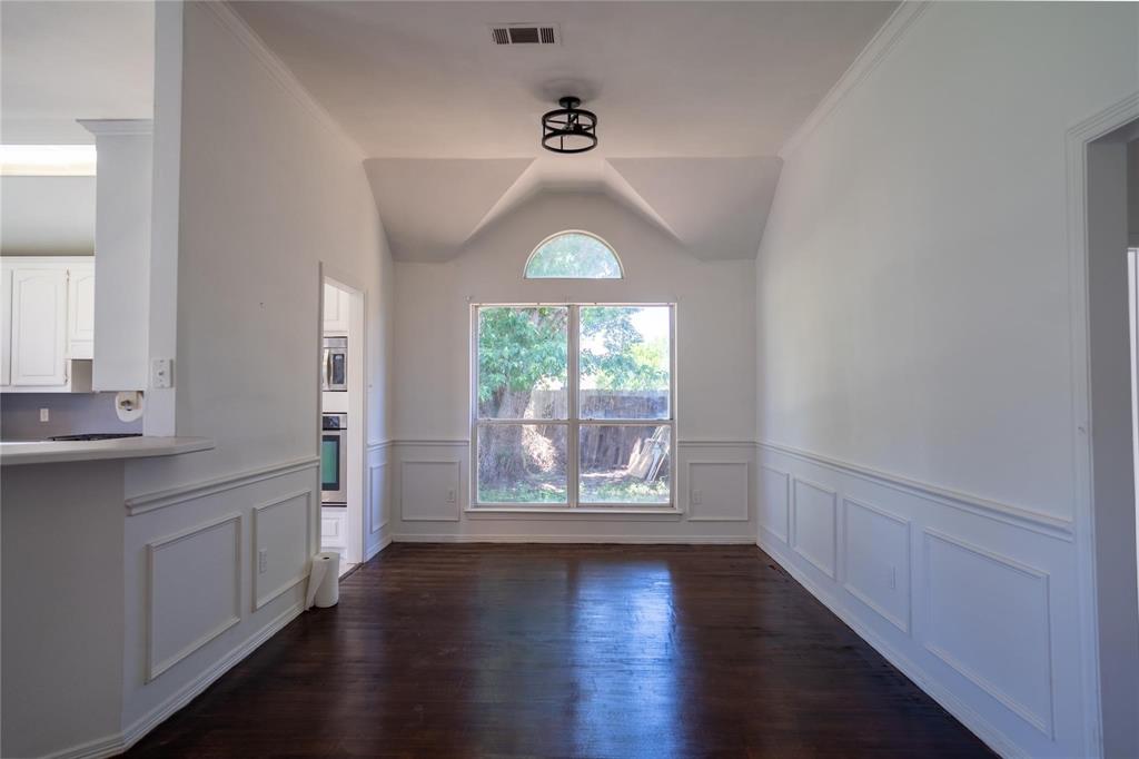492 Shade Tree Circle Hurst, TX 76054 - Photo 8 of 20 wooden floor in an empty room with a window