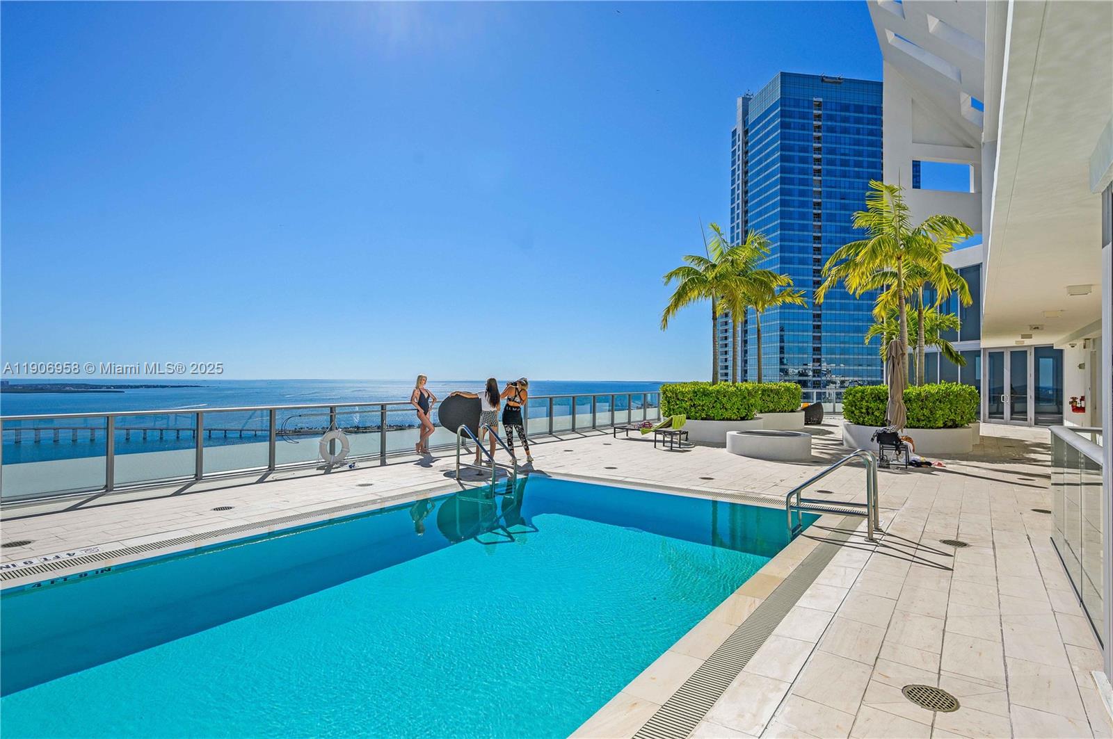 1300 Brickell Bay Drive, Unit 1603 Miami, FL 33131 - Photo 16 of 17 a swimming pool with outdoor seating and yard