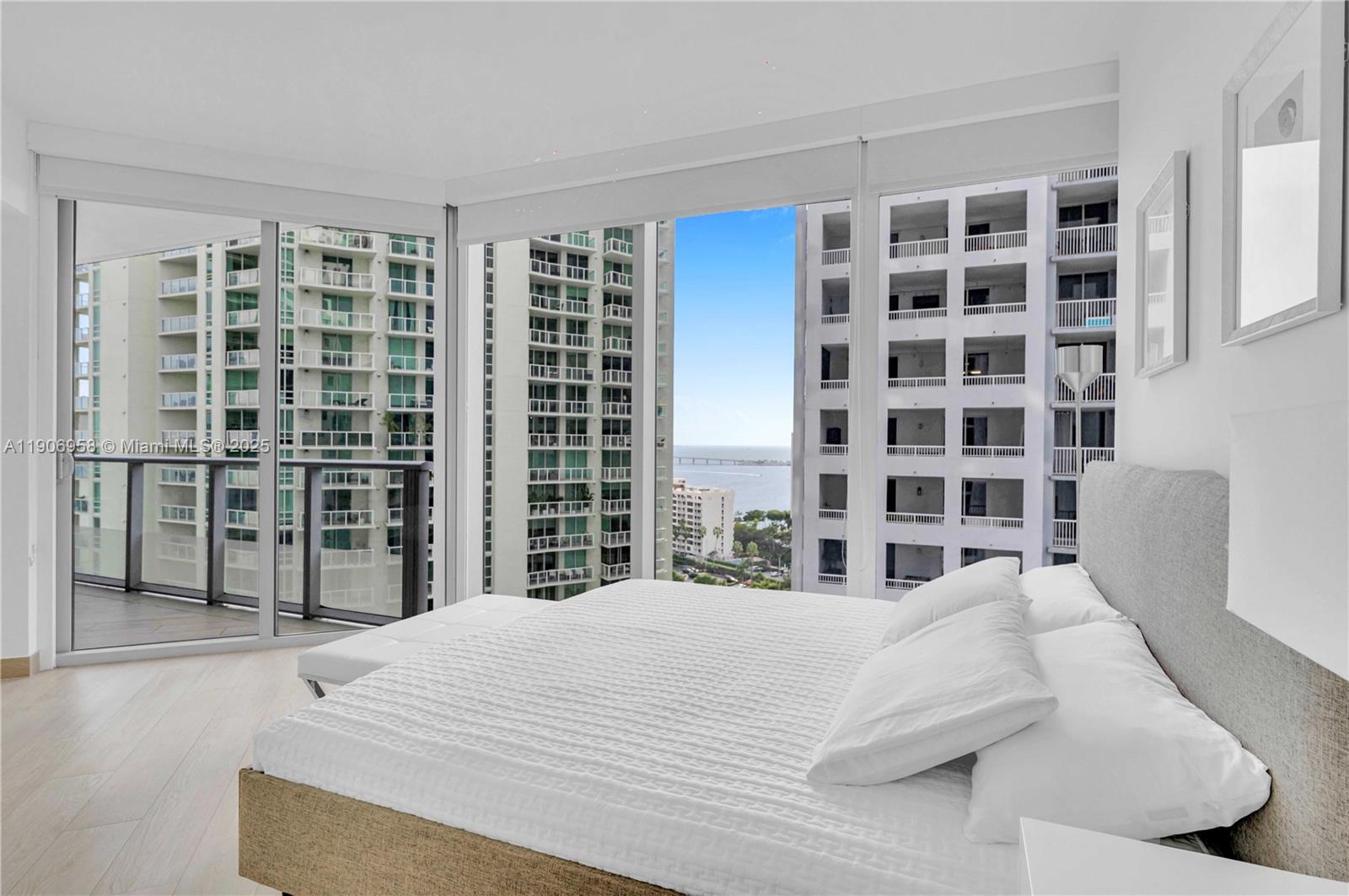 1300 Brickell Bay Drive, Unit 1603 Miami, FL 33131 - Photo 7 of 17 a bedroom with a bed and a window