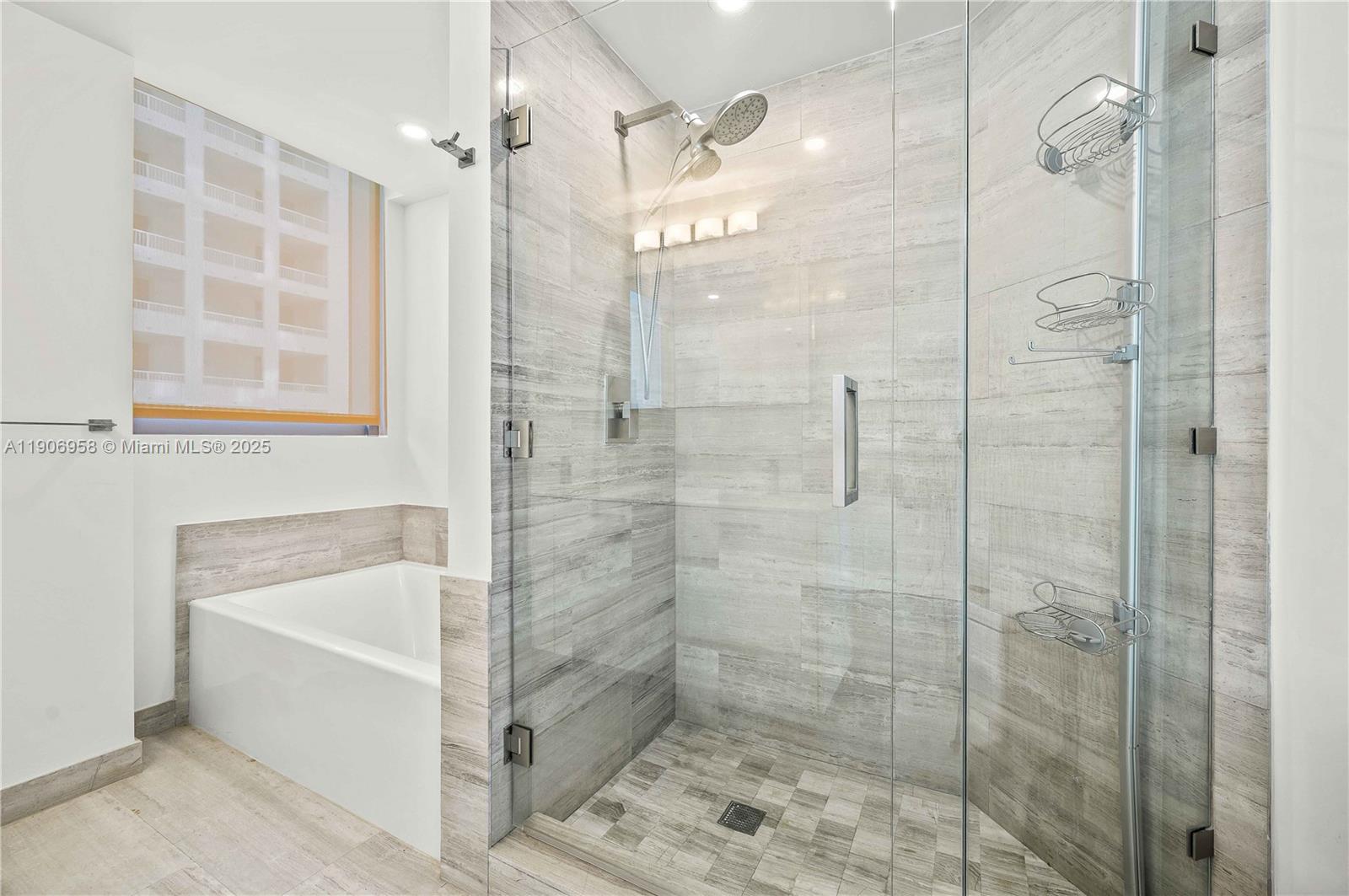 1300 Brickell Bay Drive, Unit 1603 Miami, FL 33131 - Photo 9 of 17 a bathroom with a shower and a bathtub